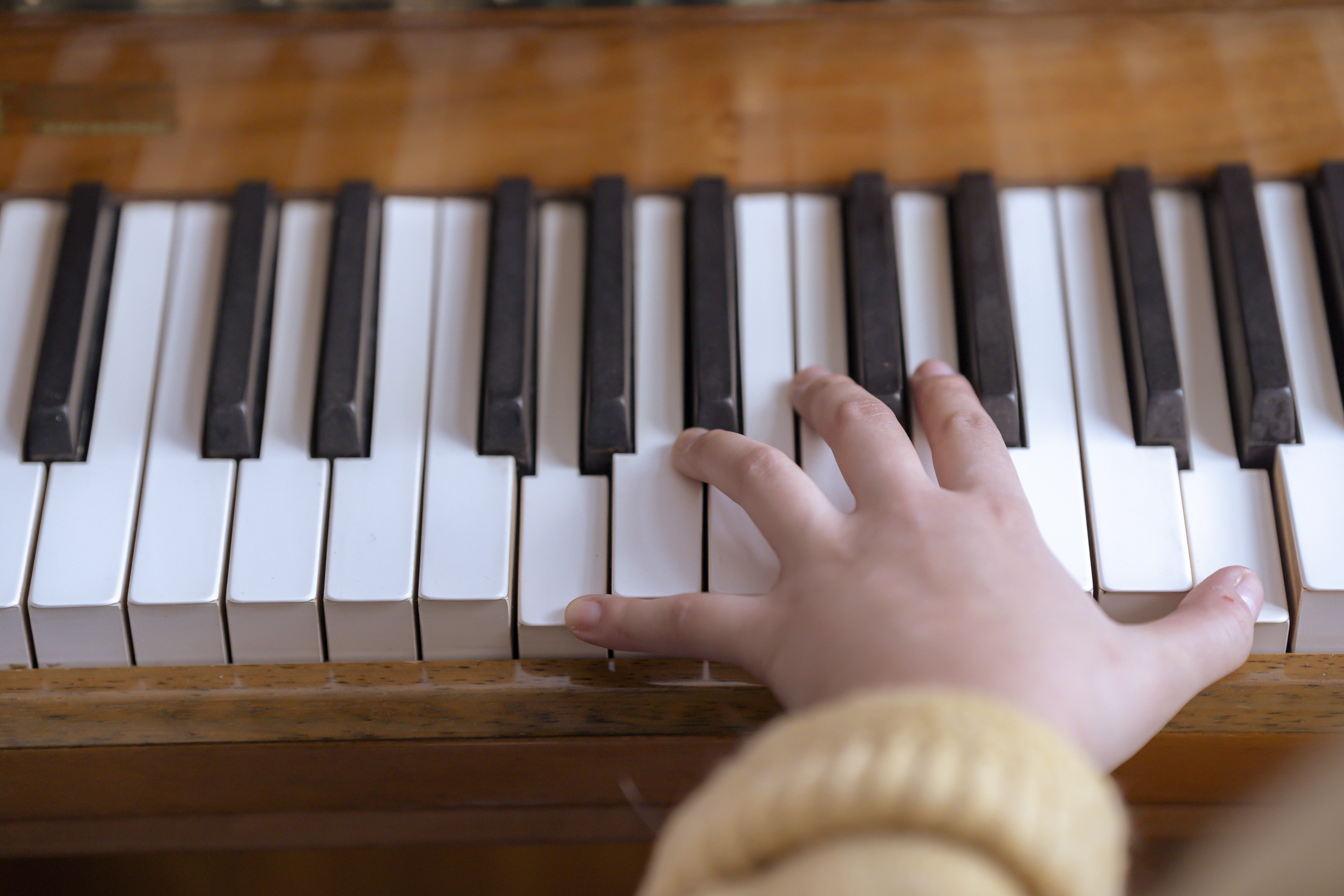 Woman playing piano during rehearsal in music hall
